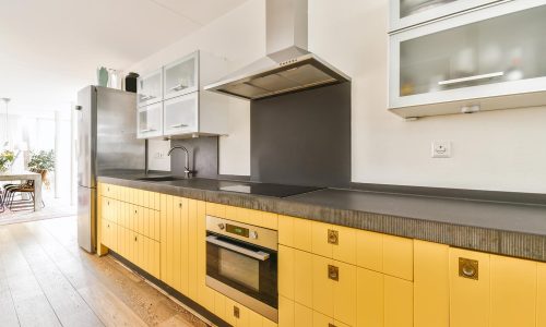 pretty-kitchen-with-yellow-kitchen-unit-and-hangin-2021-12-09-14-14-18-utc.jpg