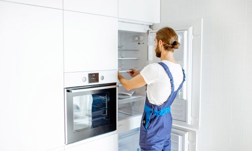 workman-installing-fridge-on-the-kitchen-at-home-2021-09-02-09-20-03-utc.jpg